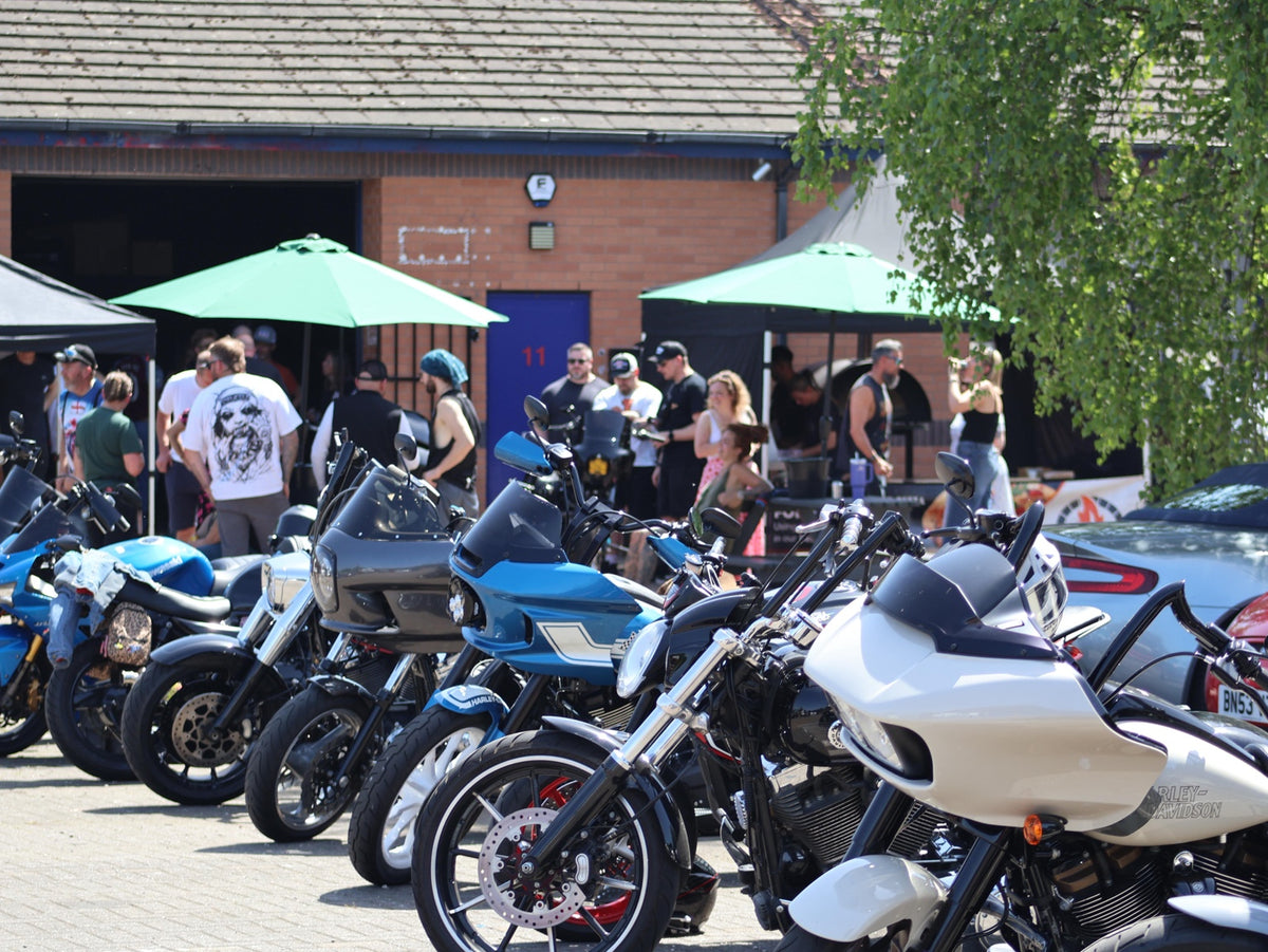 A row of custom motorcycles parked outside the workshop.