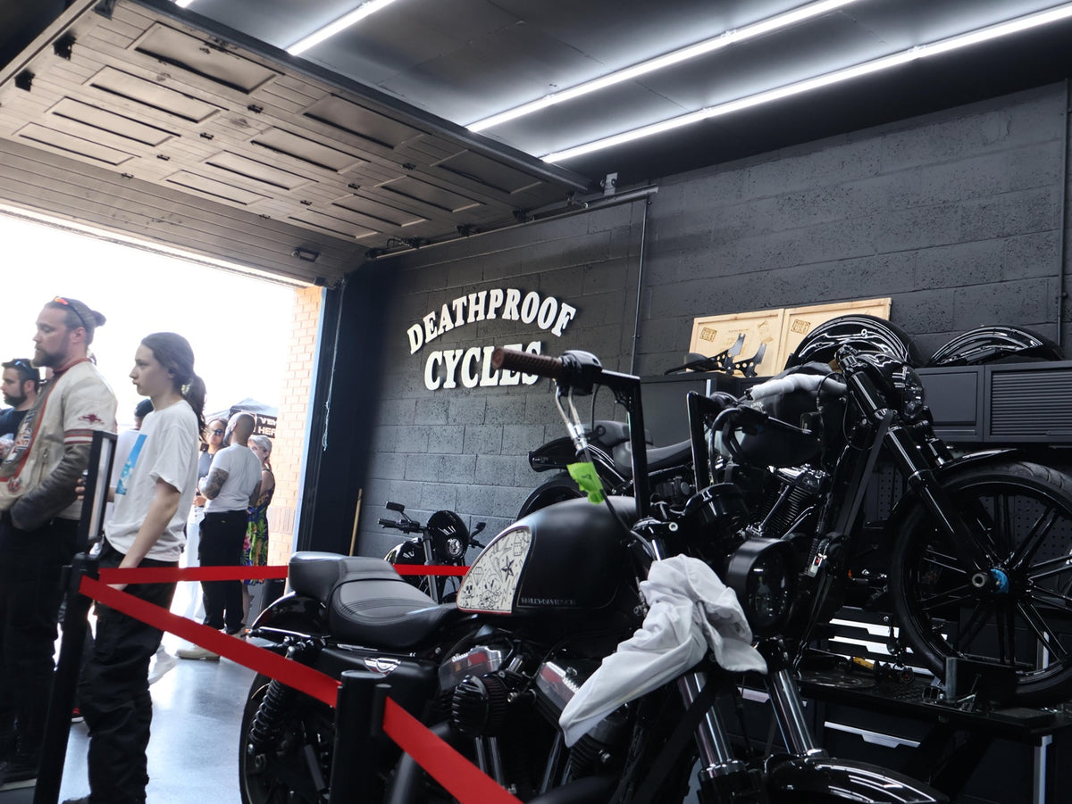 Custom motorcycles on display inside the Deathproof workshop during the opening party.
