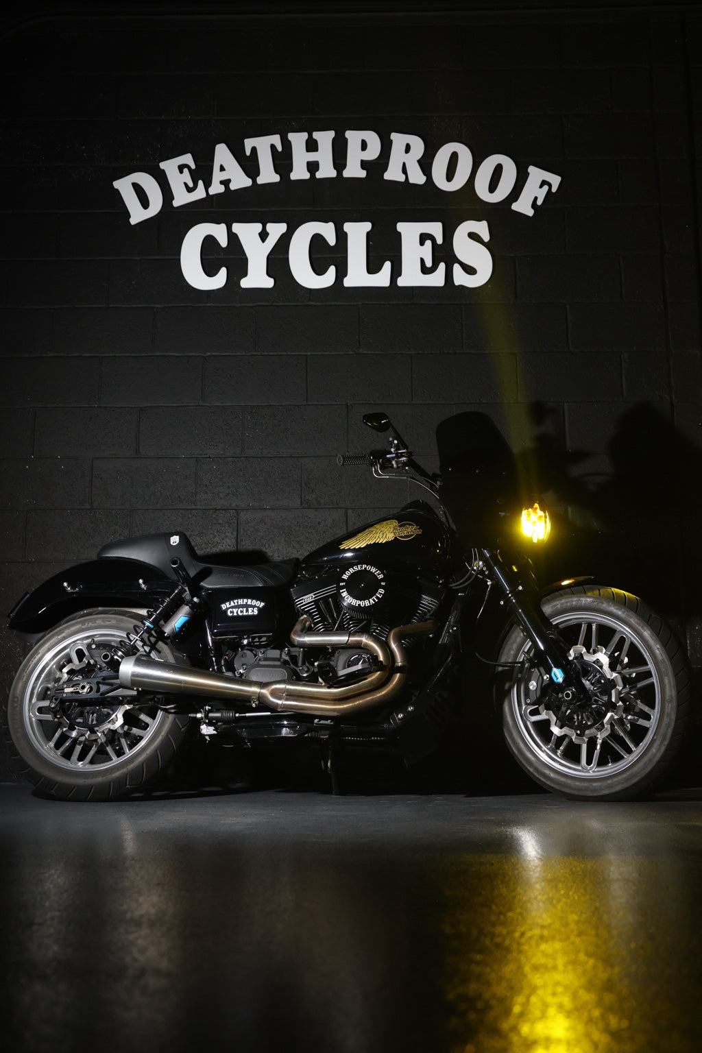 Harley-Davidson with yellow headlight at Deathproof Cycles