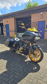 Chris’s custom Harley-Davidson with gold wheels and detailing outside Deathproof Cycles.