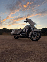 Lewis’s Harley-Davidson parked outdoors beneath a sunset sky.